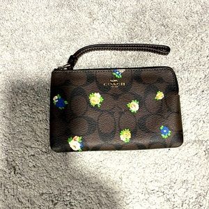 Coach small wristlet brown with flowers, Coach branding on front and back.